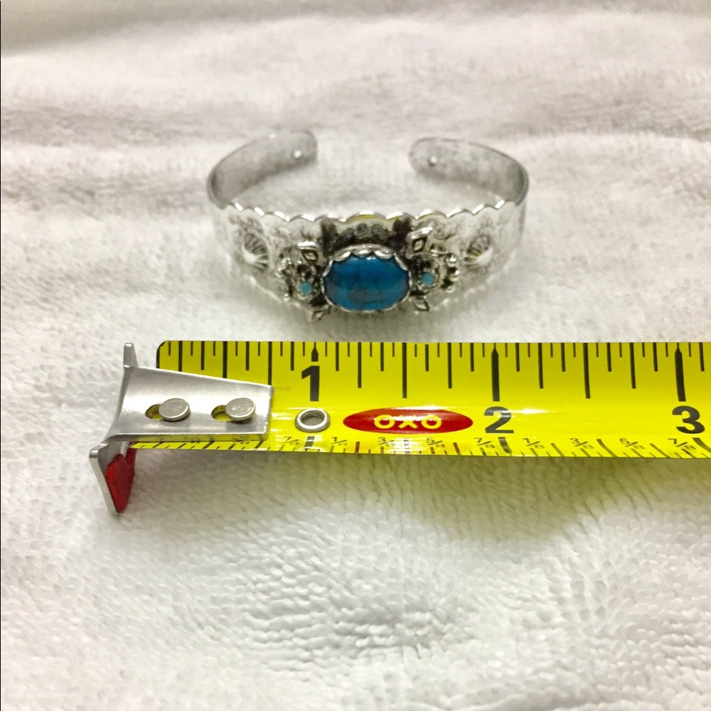 Silvertone bracelet with turquoise colored stones.